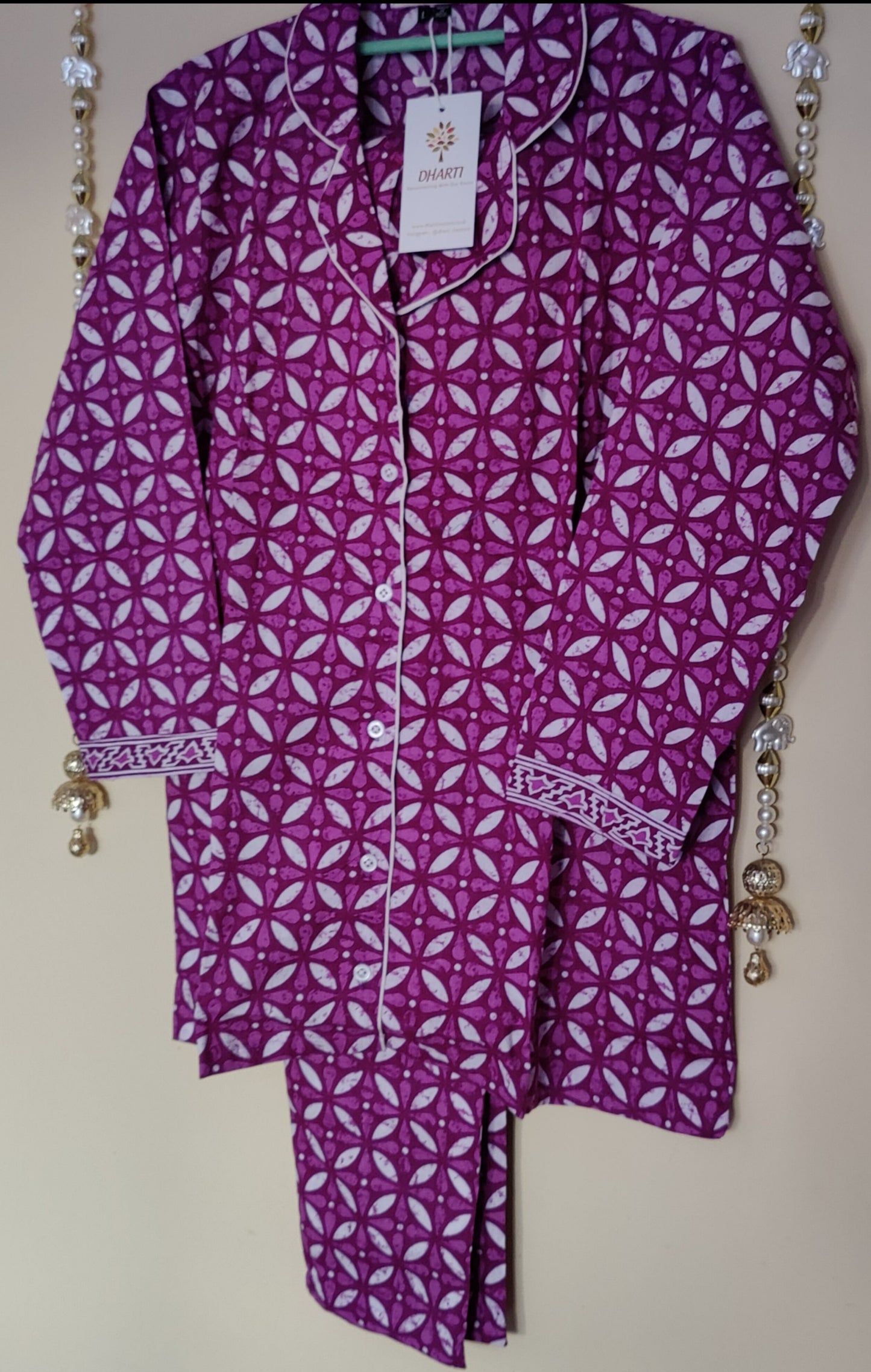 Batiq handprinted purple pyjama set on a hanger